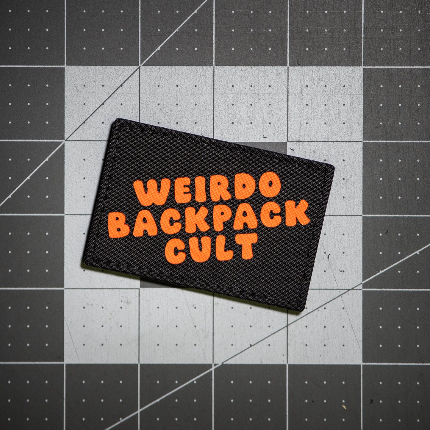 Weirdo Backpack Cult Patch - Black VX21 with Orange Letters